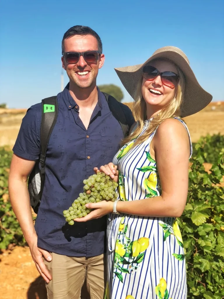 couple with grapes in vineyard tour Spain