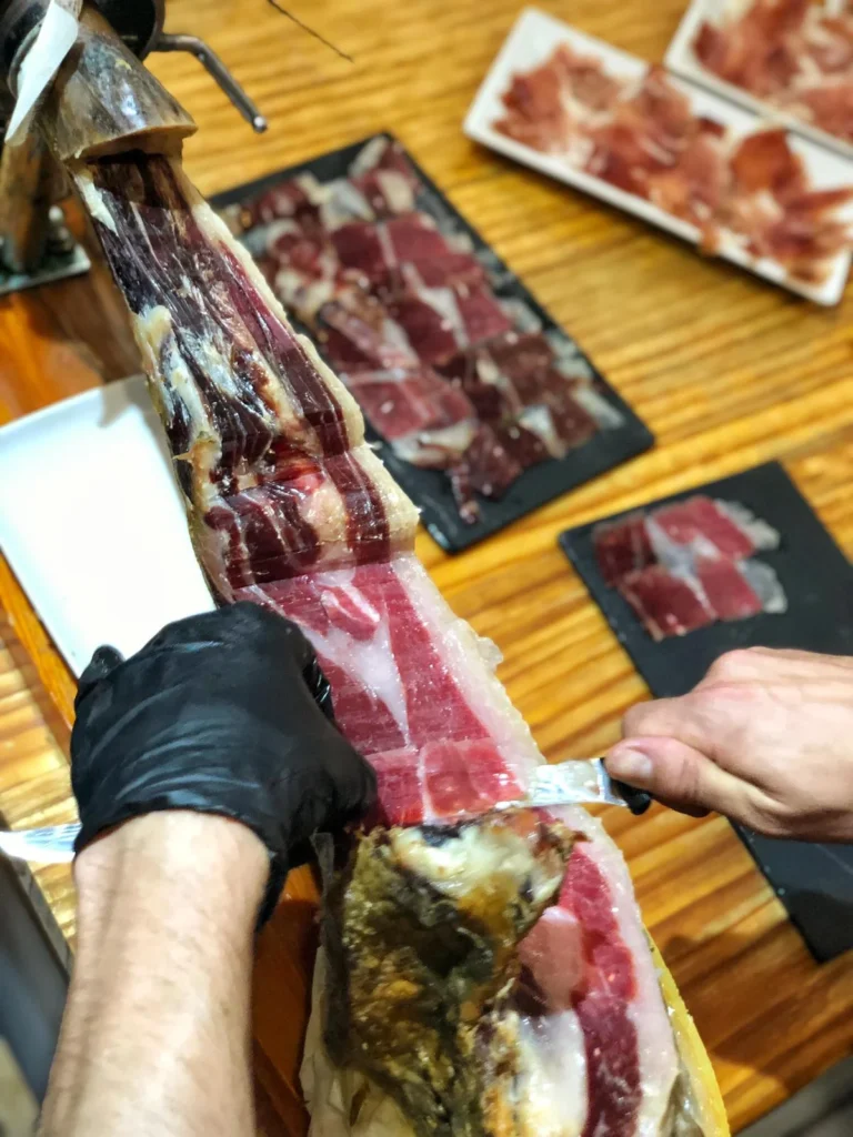 cutting jamon tapa and wine experience colorful wines